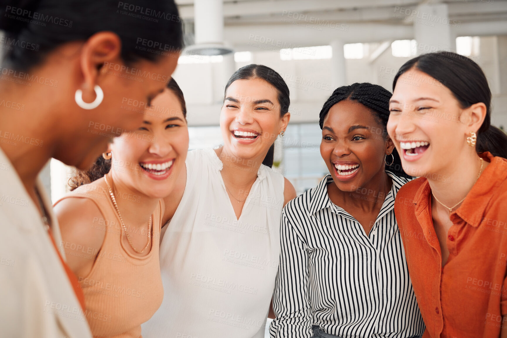 Buy stock photo Diverse group of five cheerful businesswomen having a meeting together in at work. Joyful businesspeople talking and laughing while standing in an office