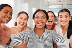 Portrait of a diverse group of five cheerful businesswomen taking a selfie together at work. Joyful businesspeople taking a photo in an office. Women working in corporate taking a picture