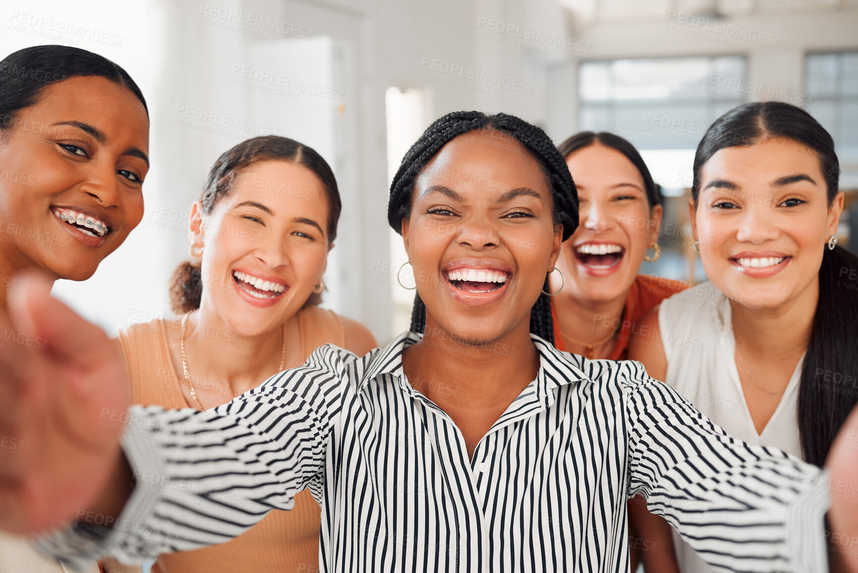 Buy stock photo Portrait of a diverse group of five cheerful businesswomen taking a selfie together at work. Joyful businesspeople taking a photo in an office. Women working in corporate taking a picture