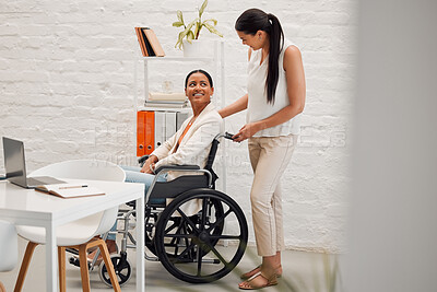 Buy stock photo Young mixed race businesswoman helping a colleague in a wheelchair to her office at work. Hispanic businessperson with a disability being helped to her desk at work