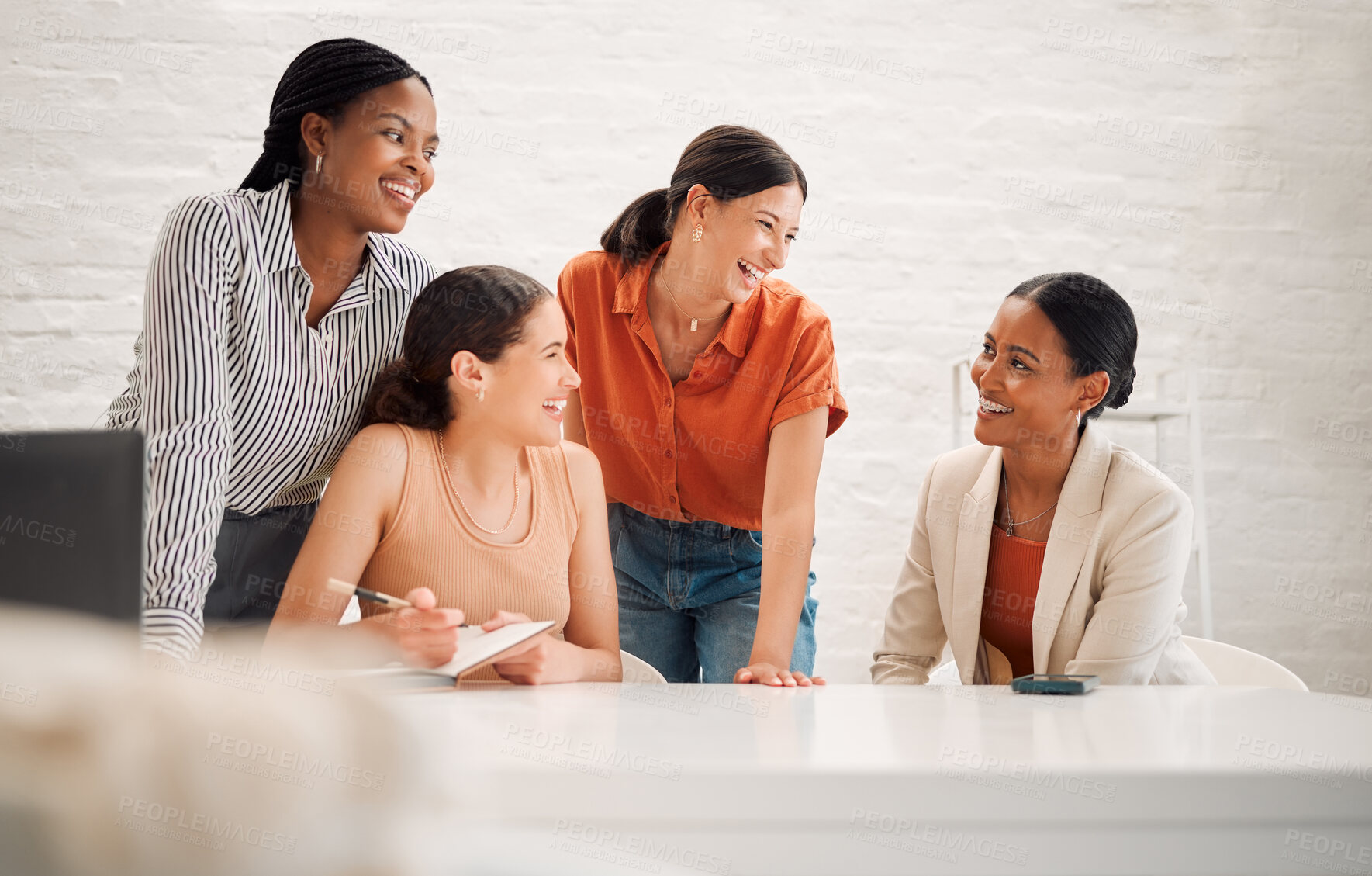 Buy stock photo Group of happy diverse businesswomen having a meeting together in a boardroom at work. Cheerful businesspeople laughing and talking while planning in a workshop in an office