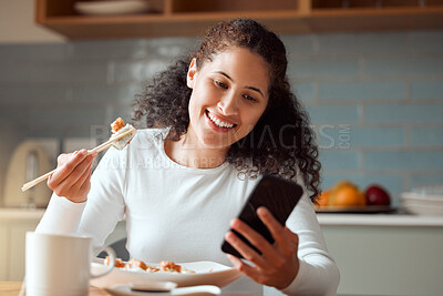 Buy stock photo Woman eating sushi and using her cellphone. Young woman sending a text on her smartphone while eating seafood. Happy woman enjoying a meal at home. Young girl eating savoury fish