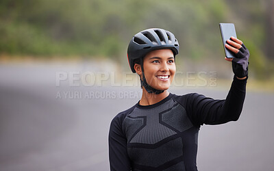Buy stock photo One athletic young woman taking a selfie using her smartphone during a break from cycling outside. Sporty fit mixed race female wearing a helmet and having poor reception