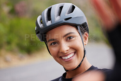 Buy stock photo Portrait of a happy smiling mixed race athletic young woman taking a selfie during a break from cycling outside .Sporty fit mixed race female wearing a helmet and taking a photo of herself
