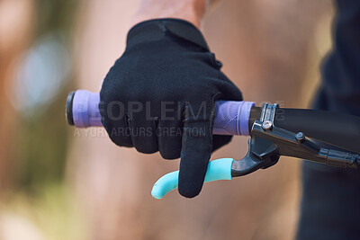 Buy stock photo Closeup of an unknown cyclist with gloves holding the handle of his bicycle while cycling outside in nature. Athlete training and testing his brakes for safety before starting his cardio workout