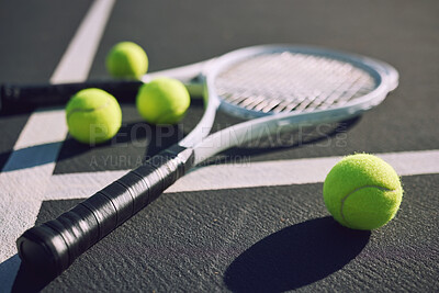 Buy stock photo Tennis racket and balls on an empty sports court outside on a sunny day. Sports gear and equipment for leisure or a professional player. A hobby that promotes exercise, fitness and wellness