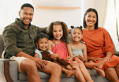Buy stock photo Portrait of a mixed race family of five relaxing on the sofa at home. Loving black family being affectionate on the sofa. Young couple bonding with their adopted kids at home