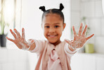 One mixed race adorable little girl washing her hands in a  bathroom at home. A happy Hispanic child with healthy daily habits to prevent the spread of germs, bacteria and illness