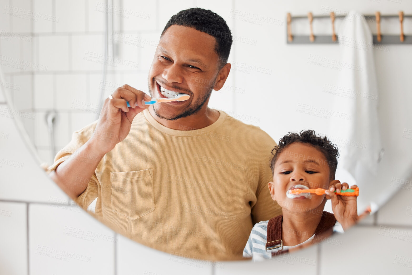 Buy stock photo Brushing teeth, father and child in a home bathroom for dental health and wellness with smile. Face of a man and african boy kid learning to clean mouth with a toothbrush and mirror for oral hygiene