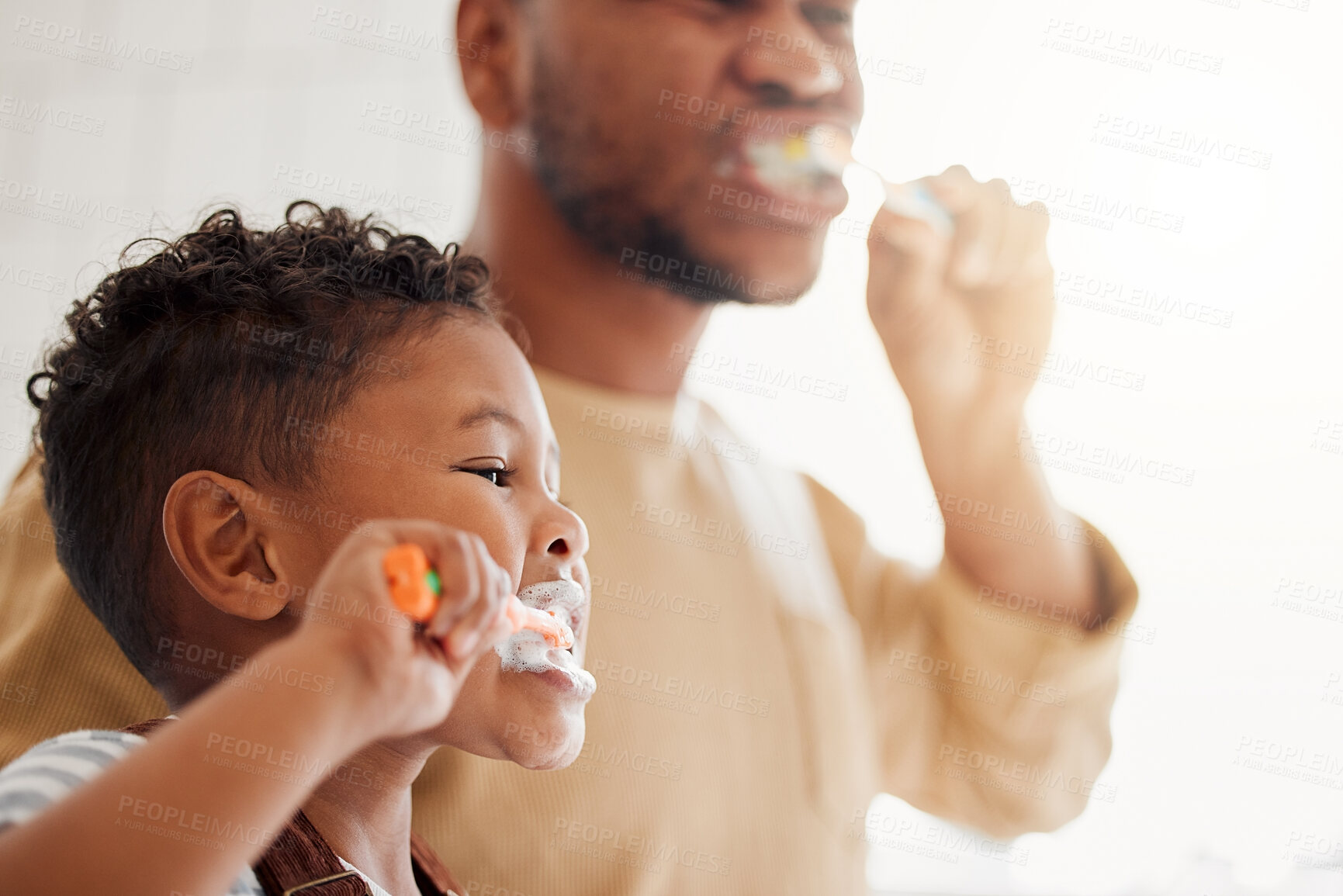 Buy stock photo Brushing teeth, child and dad in a home bathroom for dental health and wellness. Face of a man and african kid learning to clean mouth with a toothbrush and toothpaste for oral hygiene and self care