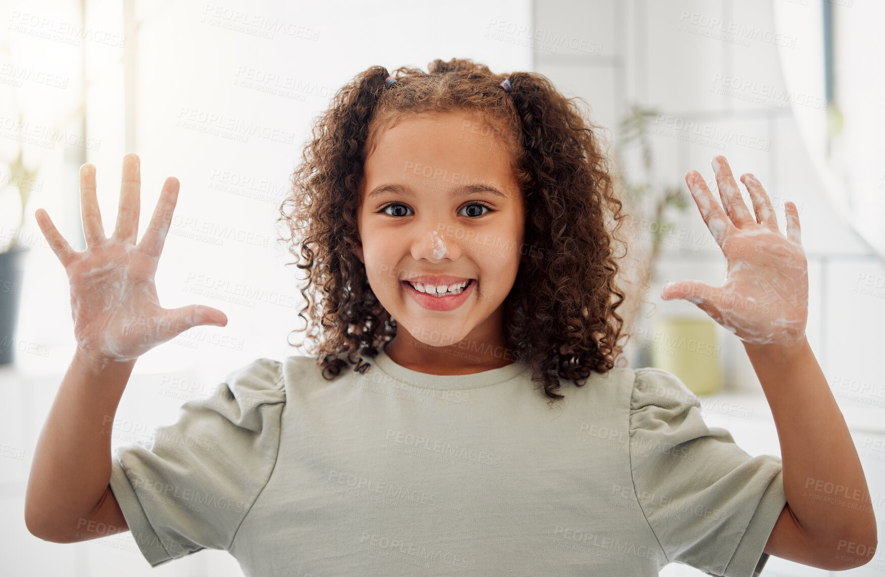 Buy stock photo One mixed race adorable little girl washing her hands in a  bathroom at home. A happy Hispanic child with healthy daily habits to prevent the spread of germs, bacteria and illness