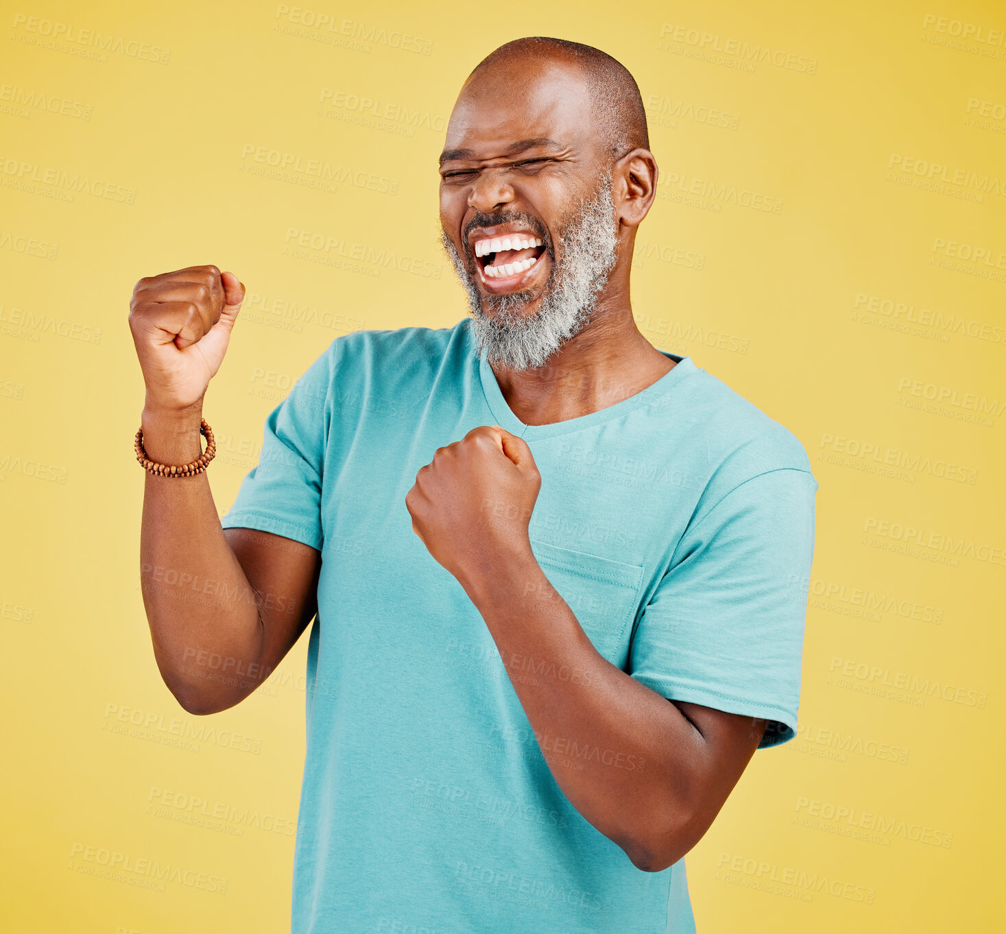 Buy stock photo A mature african man looking ecstatic while while celebrating by making a fist pump gesture with his hands and cheering against a yellow studio background. Success and Celebrations infuse life with passion and purpose 