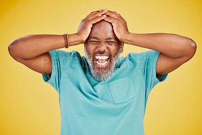 Mature African american man with grey beard standing with his hands on his head and looking shocked or surprised while shouting. Man with astonished facial expression while standing against yellow studio background
