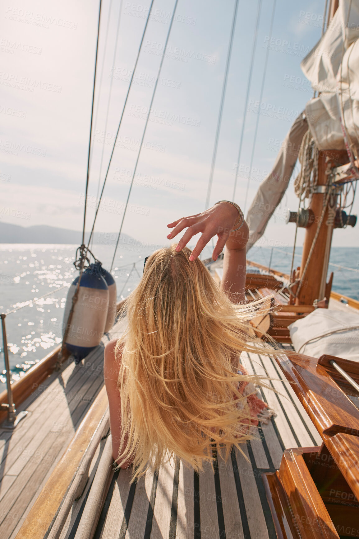 Buy stock photo Back, travel and a woman on a yacht for a luxury cruise at sea during summer for a vacation or holiday. Water, view and horizon with a female tourist or traveler sitting on a boat in the ocean