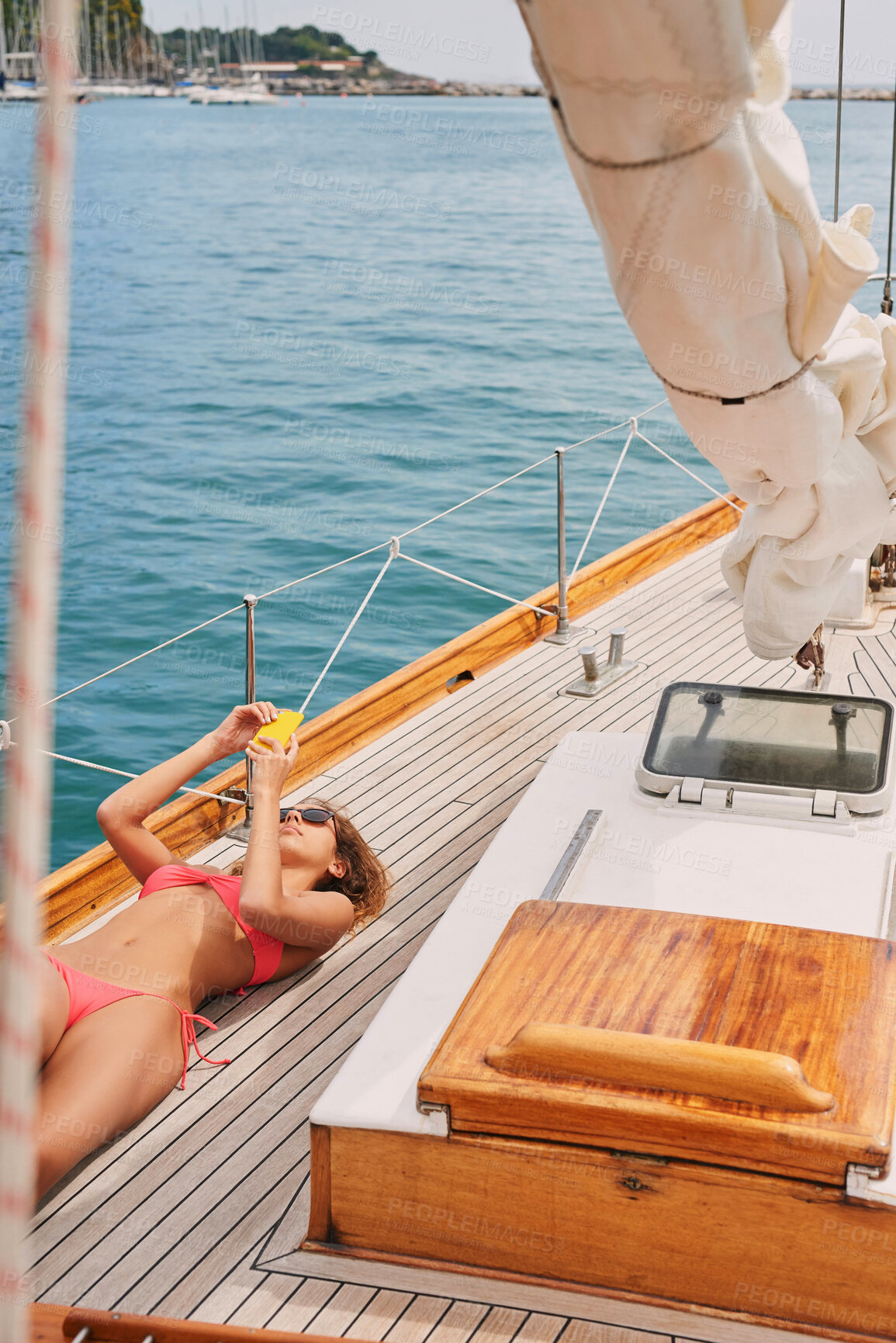 Buy stock photo Travel, social media and woman with phone on boat relax for cruise on holiday, vacation and adventure at sea. Luxury sailing, sunbathing and female person on smartphone for internet, message and text