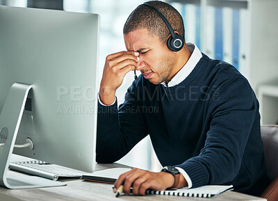 Buy stock photo Stress, call center and a man with a headset at computer for customer service problem. African person consultant at pc with headache for telemarketing mistake, crm support and help desk or sales fail