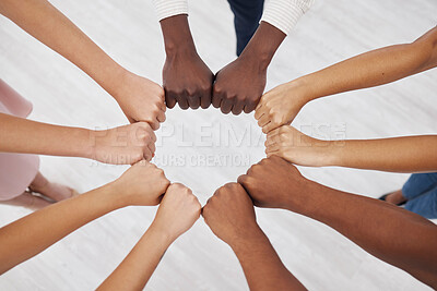 Buy stock photo Hands, collaboration and overhead with a business team standing in a circle for unity or solidarity at work. Teamwork, fist bump and support with a diverse group of colleagues in a huddle from above