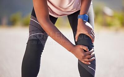 Buy stock photo Active woman holding her leg in pain while exercising outdoors. Closeup of an athlete suffering with a painful knee injury, causing discomfort and strain. Bone and muscle sprain from a fractured joint