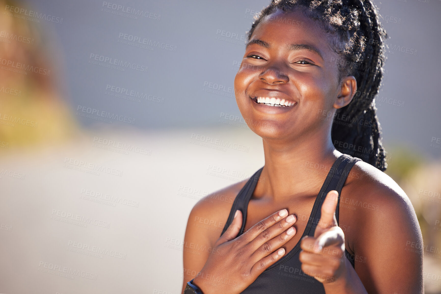 Buy stock photo One happy young fit african american woman standing alone and pointing while feeling confident after a workout. Fit and active black woman with braids feeling proud after routine training and exercise