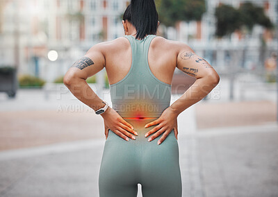 Closeup shot of a young african american woman suffering with back pain while working out in the city. Superimposed cgi highlighting an injury where a female athlete is struggling with lower back ache