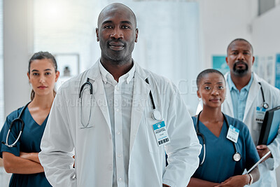 Group of serious doctors standing together while working at a hospital. Expert medical professionals looking focused at work at a clinic