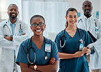 Group of happy diverse doctors standing with their arms crossed while working at a hospital. Content expert medical professionals smiling at work together at a clinic