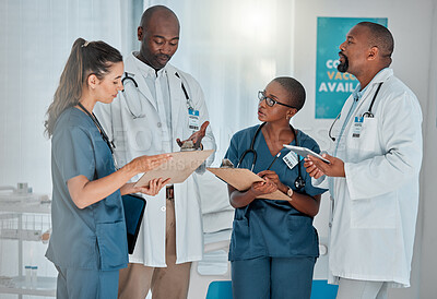 Buy stock photo Group of diverse doctors having a meeting together working at a hospital. Team of medical professionals talking while planning their day at work at a clinic