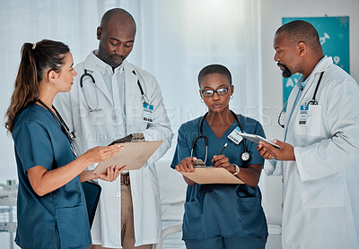 Buy stock photo Group of diverse doctors having a meeting together working at a hospital. Team of serious medical professionals talking while planning their day at work at a clinic