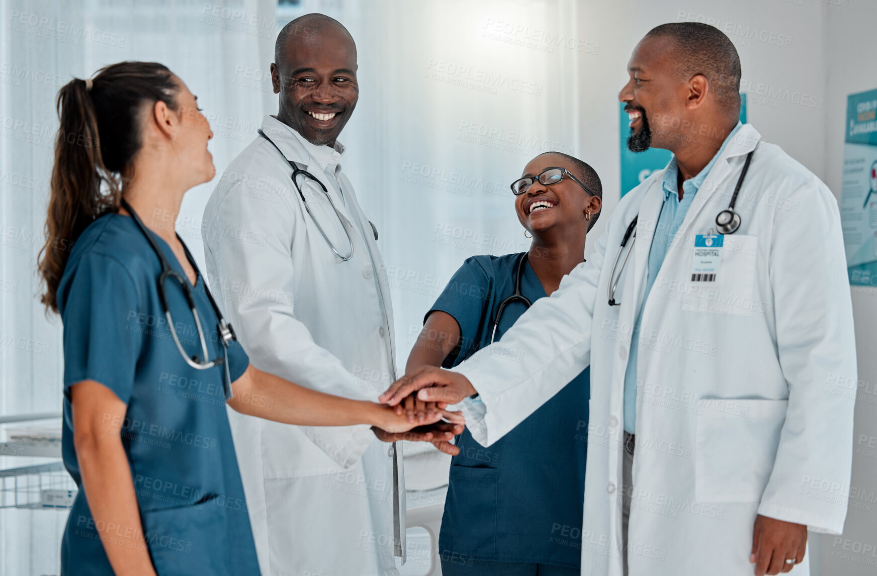 Buy stock photo Group of happy diverse doctors stacking their hands together in support while working at a hospital. Medical professionals joining their hands in unity and motivation while working at a clinic