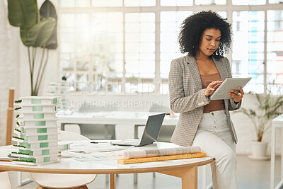 Buy stock photo Leading businesswoman using a digital tablet. Creative entrepreneur using an online app. Young architect working in her agency. Focused businesswoman using a wireless device in her office