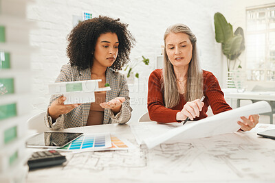 Buy stock photo Mature businesswoman collaborates with a colleague. Two businesspeople brainstorm during a meeting. Team of designers working on a building project. Architects working on a building project together