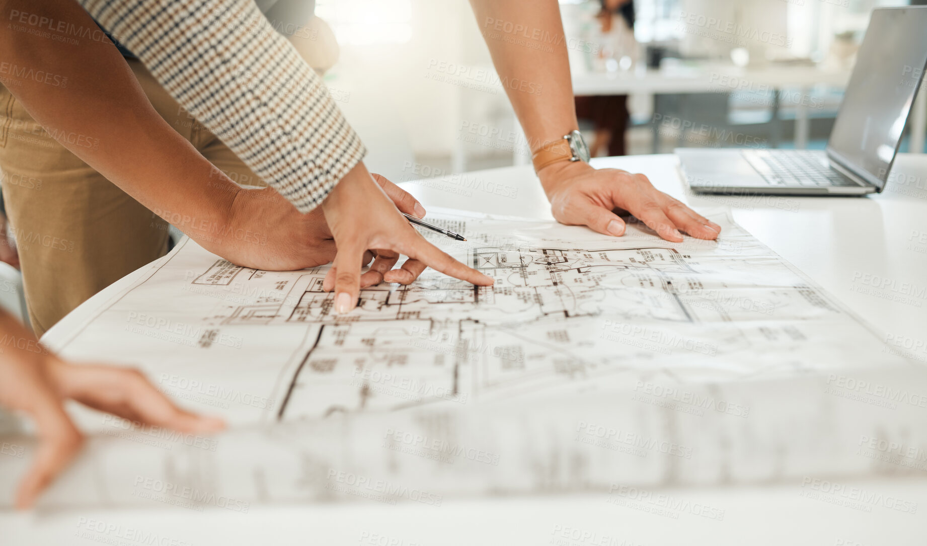 Buy stock photo Closeup of businesspeople working on a blueprint. Two colleagues planning a building project. hands of engineers writing on a blueprint. Team of architects working on a building plan