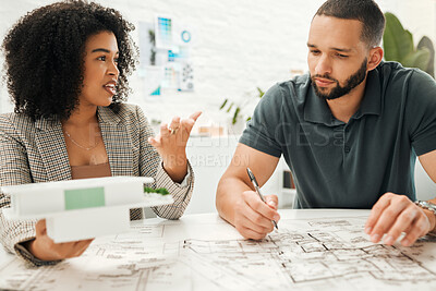 Buy stock photo Two architectural coworkers planning a building project. Young designers working on a blueprint. Businesspeople collaborate on a building project. Professional designers working together on a 3D model