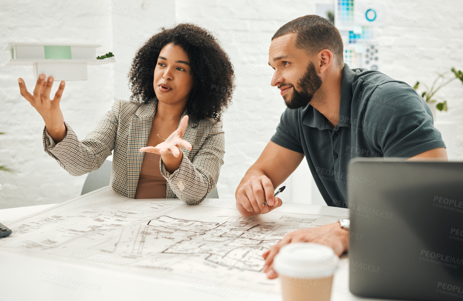 Buy stock photo architect coworkers planning a building together. Businesspeople working on an architectural project together. Team of engineers collaborate on a 3D building model. Designers work on building model