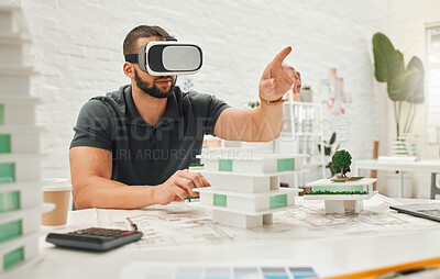 Young businessman playing with a VR headset. Architect playing a game on AI goggles. Young engineer pointing while using virtual reality headset. Businessman wearing simulation goggles
