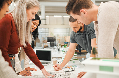Buy stock photo Group of engineers looking at a blueprint. Architects in a business meeting. Businesspeople collaborate together.Diverse corporate creatives plan engineering project. Coworkers brainstorm together