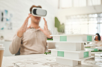 Designer using VR headset to plan his building.Architect playing with virtual reality goggles. Designer using AI architecture simulator. Businessman planning his building project with VR goggles