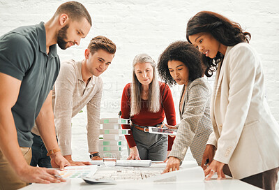Buy stock photo Businesspeople brainstorm together. Group of businesspeople planning a blueprint together. Engineers collaborate about building plan. Architects planning a strategy together.