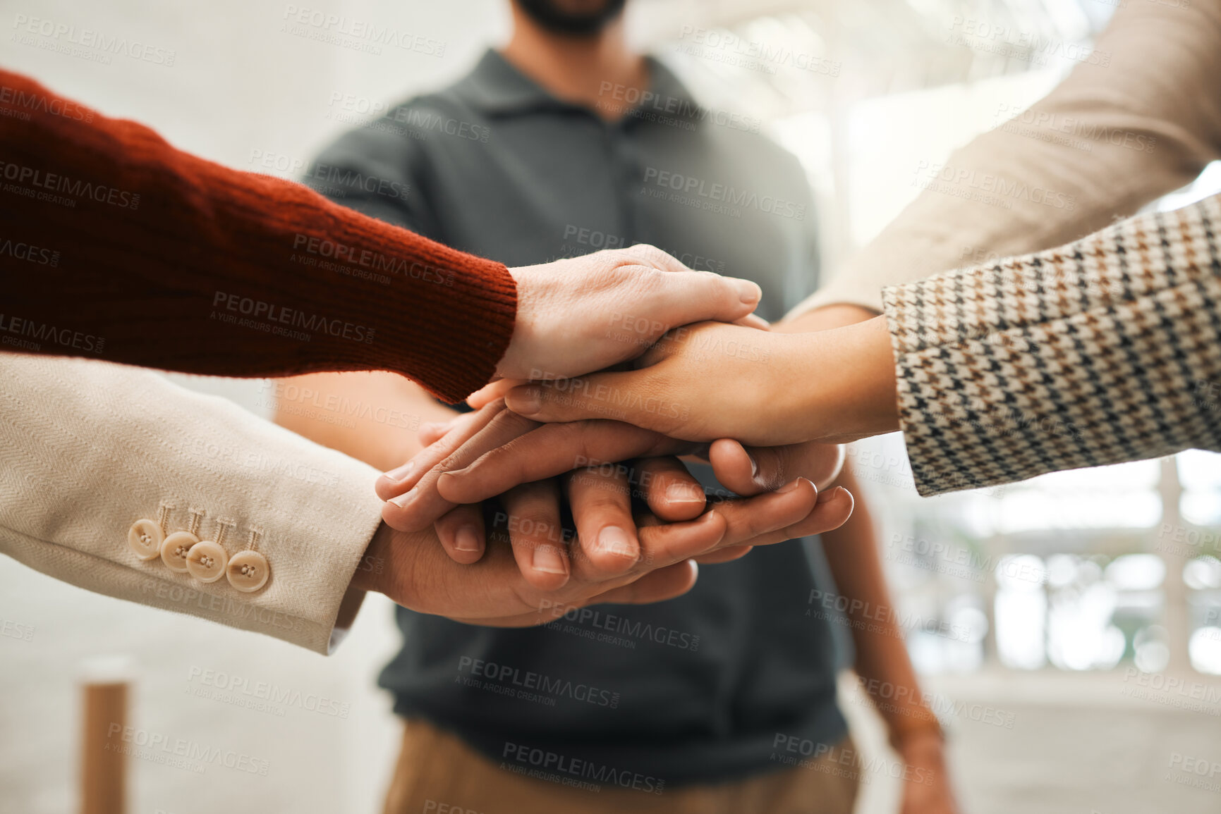 Buy stock photo Group of businesspeople with hands stacked. Corporate professionals giving each other motivation. Closeup of hands of businesspeople huddled together. Architects united with hands stacked