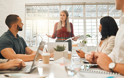 Buy stock photo Mature boss asking staff a question in a meeting. Businesswoman collaborating in a meeting. Senior architect using a report during a meeting.Diverse staff brainstorming together