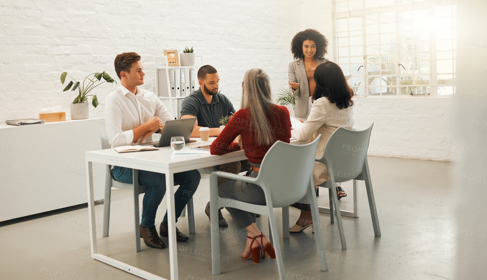 Buy stock photo Businesspeople brainstorm in a meeting. Young businesswoman talking to staff member. Architects collaborating in a meeting. Diverse coworkers talking in a meeting.