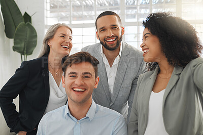 Buy stock photo Group of four cheerful diverse and positive businesspeople taking a selfie together at work. Happy hispanic businesswoman taking a photo with her joyful colleagues