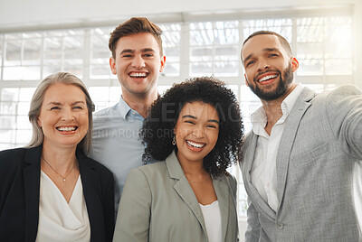 Buy stock photo Portrait of a group of four cheerful diverse and positive businesspeople taking a selfie together at work. Happy mixed race businessman taking a photo with his joyful colleagues