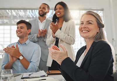 Buy stock photo Group of businesspeople in a meeting together at work. Mature caucasian businesswoman clapping with her colleagues while in a workshop. Business professionals clapping in support in an office