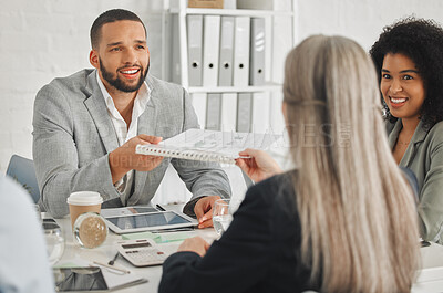 Buy stock photo Young happy mixed race businessman giving a report to a female caucasian colleague while in a meeting together at work. Businesswoman taking a document from an hispanic male coworker