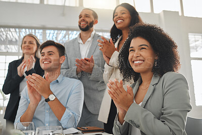 Buy stock photo Group of businesspeople in a meeting together at work. Young cheerful mixed race businesswoman with a curly afro clapping with her colleagues while in a workshop. Business professionals clapping in support in an office