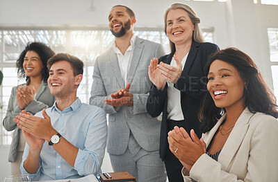 Buy stock photo Group of businesspeople in a meeting together at work. Young cheerful african american businesswoman clapping with her colleagues while in a workshop. Business professionals clapping in support in an office