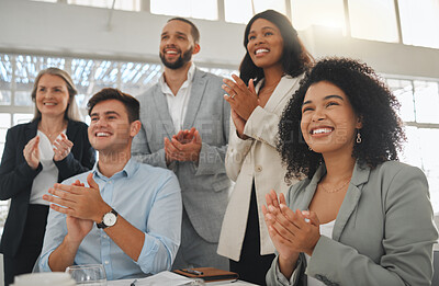 Buy stock photo Group of businesspeople in a meeting together at work. Young joyful hispanic businesswoman with a curly afro clapping with her colleagues while in a workshop. Business professionals clapping in support in an office
