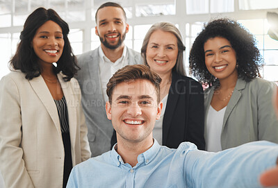 Buy stock photo Portrait of a group of five cheerful diverse and positive businesspeople taking a selfie together at work. Young happy caucasian businessman taking a photo with his joyful colleagues. Coworkers bonding in an office