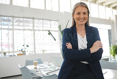 Buy stock photo Mature happy caucasian businesswoman standing with her arms crossed while in an office alone. One confident and content female boss smiling and standing at work